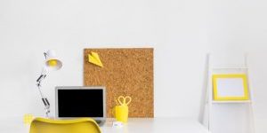 creative-bright-cabinet-with-yellow-chair-and-cork-board_23-2147878324